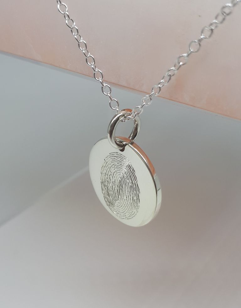 20mm silver disc pendant with hand engraved fingerprint.