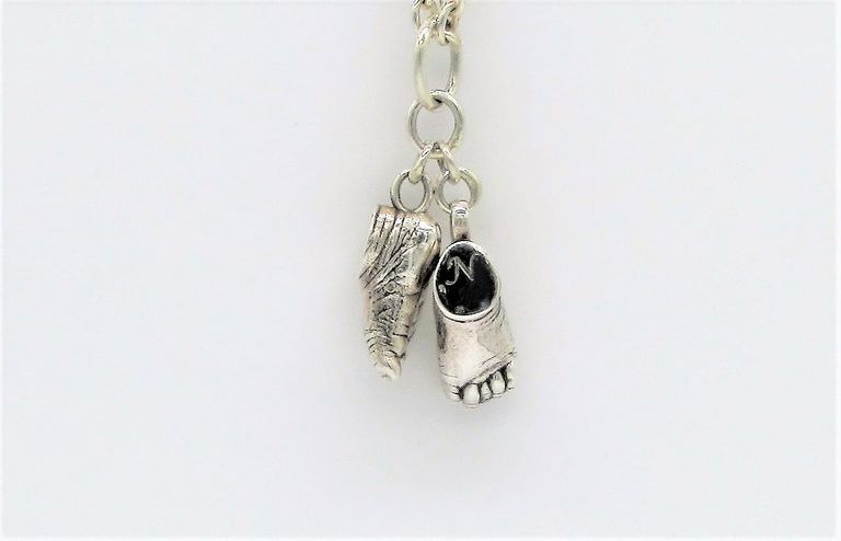 Silver feet charms on a link chain