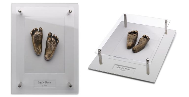 Two images of small bronze resin baby feet in a bespoke acrylic open frame. One face on and the other at an angle so you can see the sides of the feet