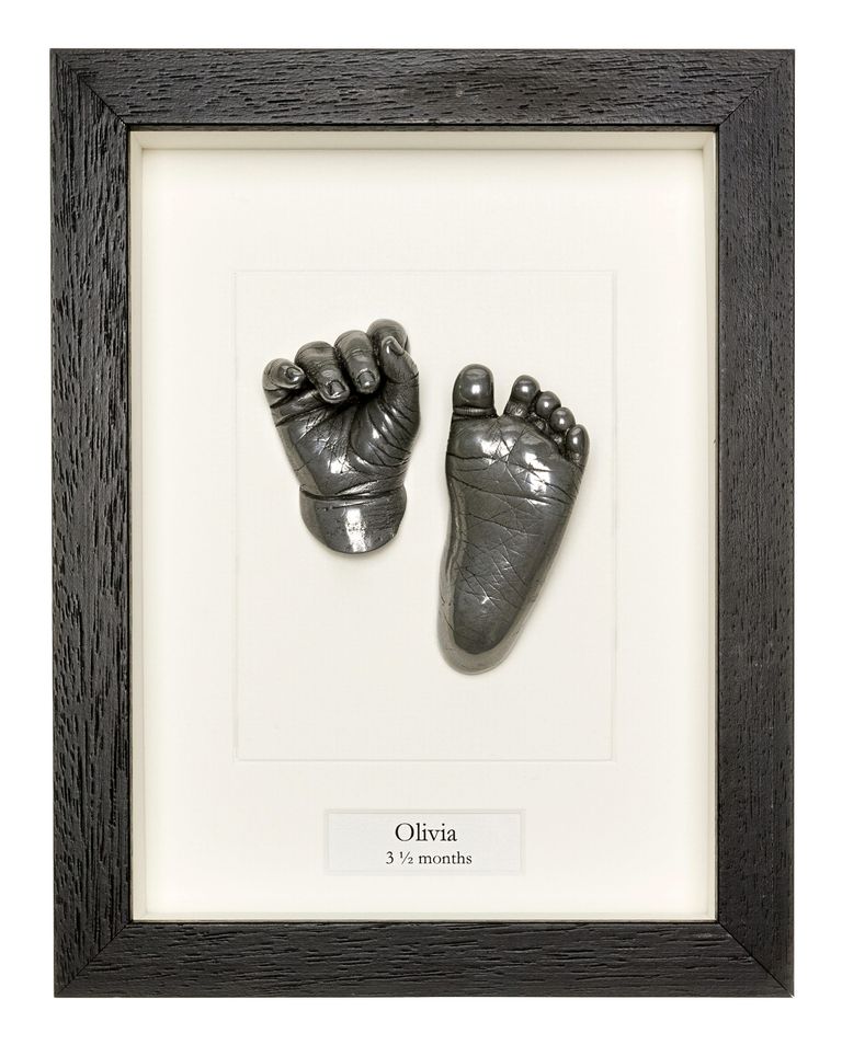 A baby's hand and foot in aluminium cold cast set in a black handmade box frame