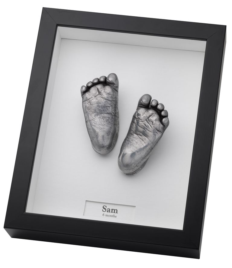 6 month old baby feet in a smooth black frame