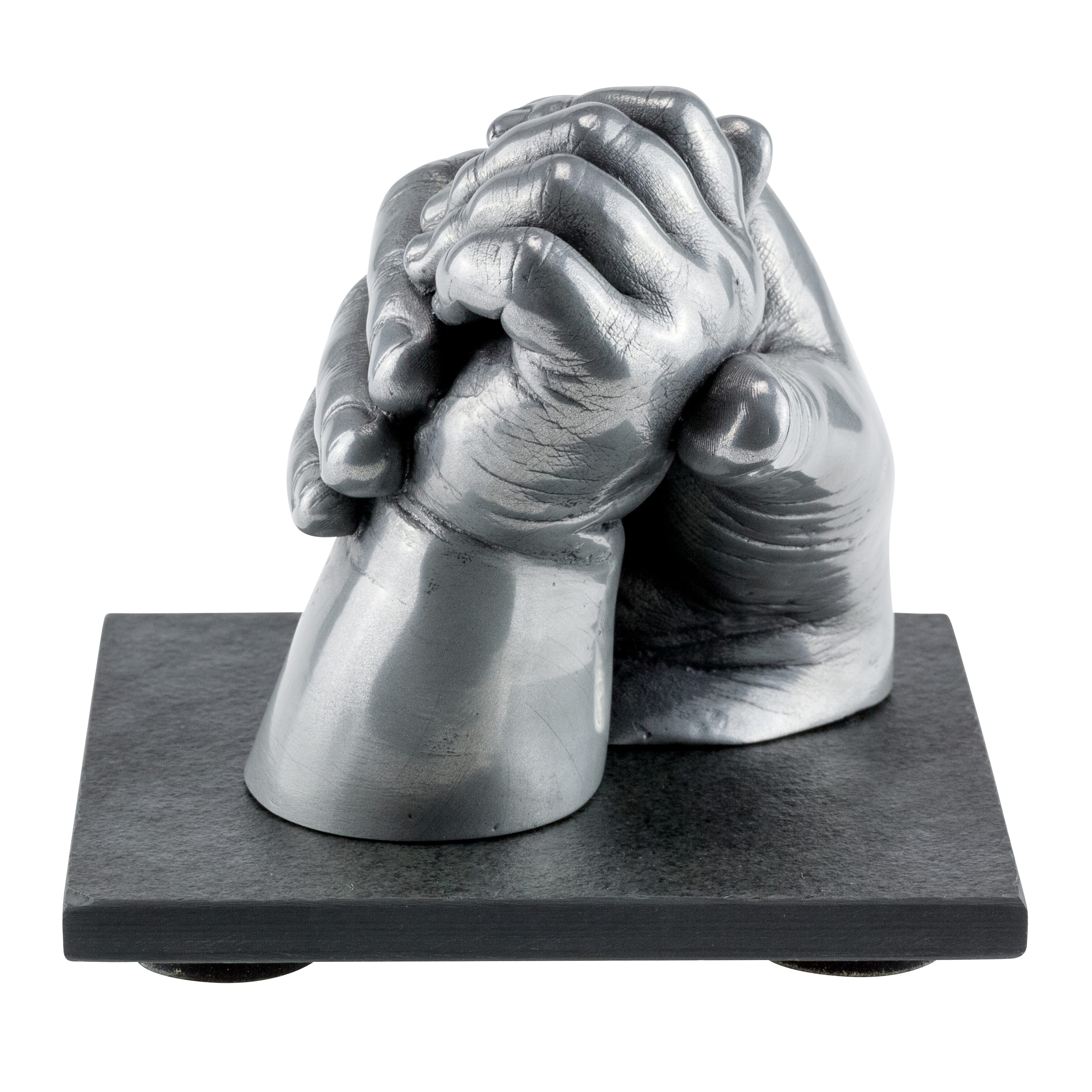 Aluminium resin cast of two siblings playfully holding hands set on a slate base
