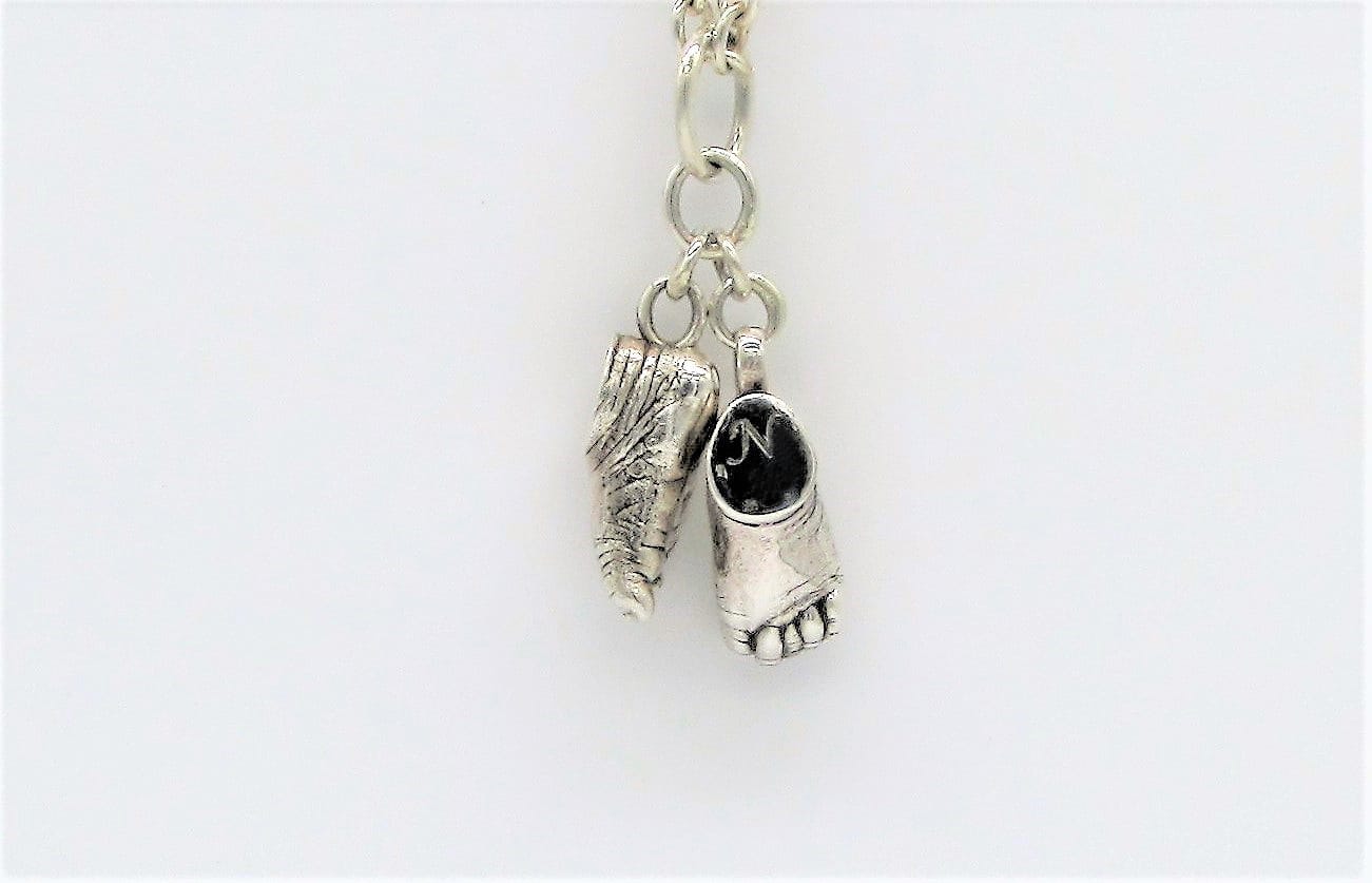Silver feet charms on a link chain